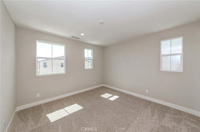 spare room with light colored carpet