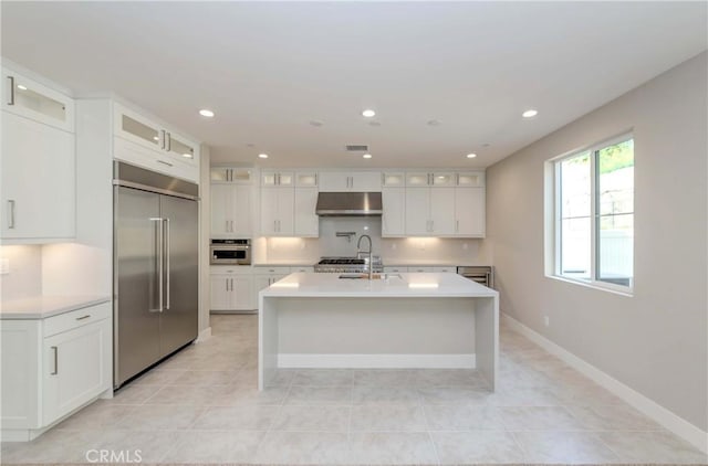 kitchen featuring sink, white cabinets, stainless steel appliances, and light tile patterned floors