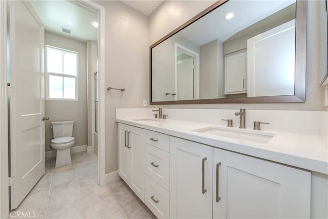 bathroom with tile patterned floors, vanity, and toilet