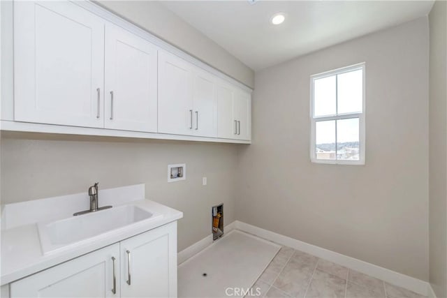 washroom featuring cabinets, washer hookup, light tile patterned floors, and sink