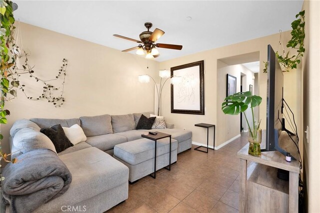 living room featuring tile patterned flooring and ceiling fan