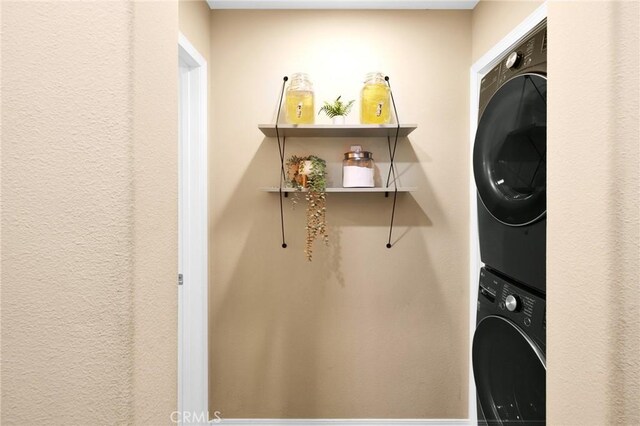 laundry room with stacked washer / dryer