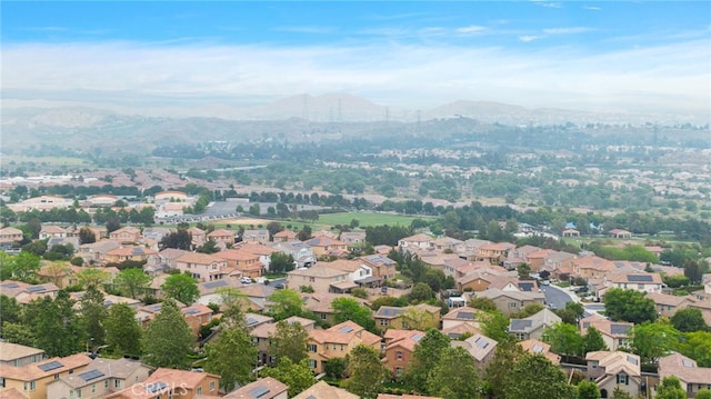 birds eye view of property featuring a mountain view