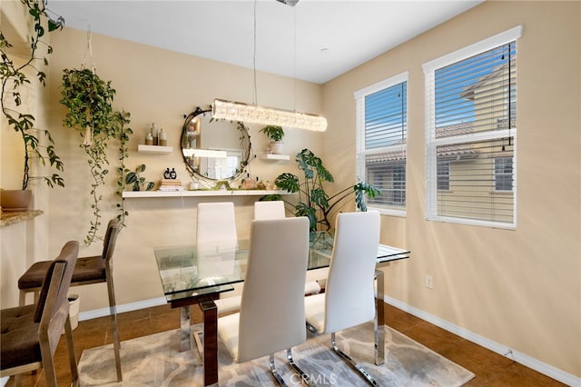 dining room featuring baseboards and tile patterned floors