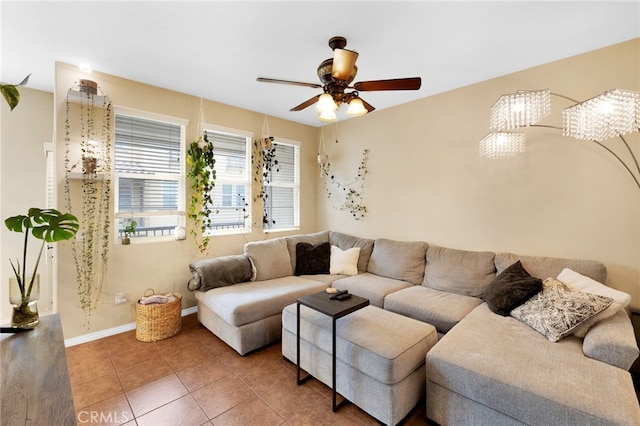 living room with ceiling fan, baseboards, and tile patterned floors