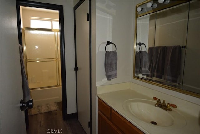 bathroom with shower / bath combination with glass door and vanity