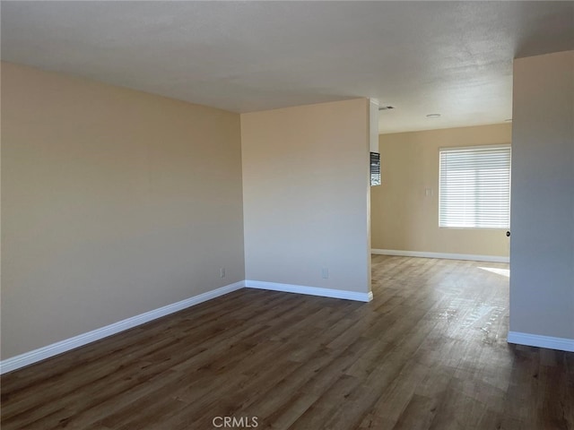 unfurnished room featuring dark hardwood / wood-style floors