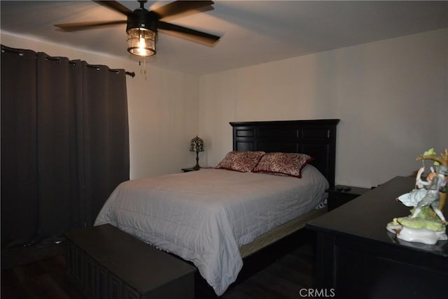 bedroom featuring dark hardwood / wood-style floors and ceiling fan