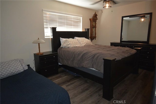 bedroom with ceiling fan and dark wood-type flooring