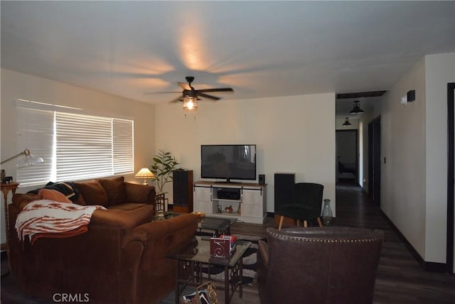 living room with dark hardwood / wood-style flooring and ceiling fan