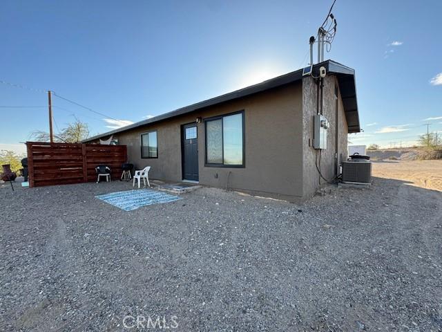 rear view of property with a patio and central AC unit