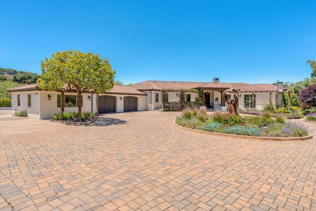 mediterranean / spanish house with a garage