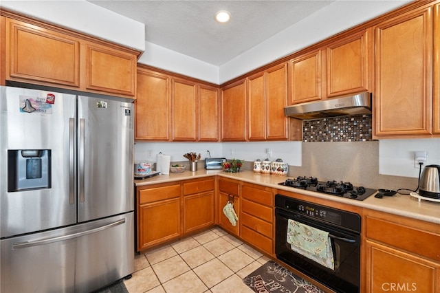 kitchen with a textured ceiling, black appliances, light tile patterned floors, and range hood