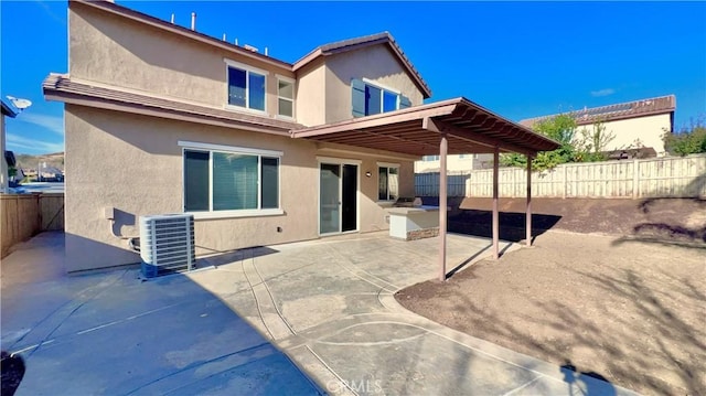 rear view of property featuring central air condition unit and a patio