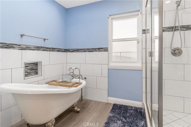 bathroom with independent shower and bath, wood-type flooring, and tile walls