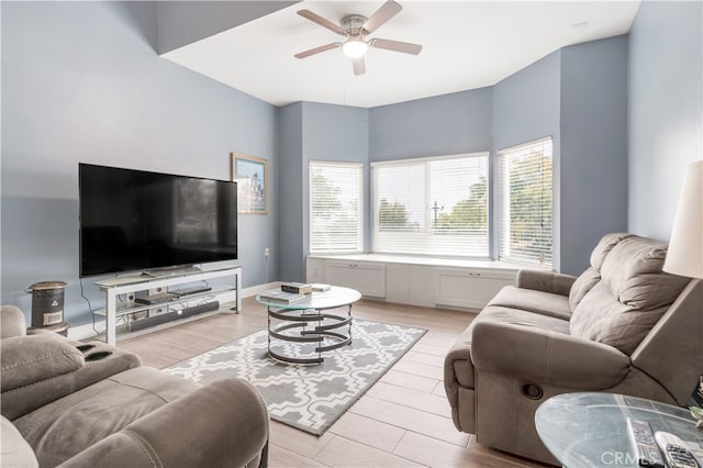 living room with light hardwood / wood-style floors and ceiling fan