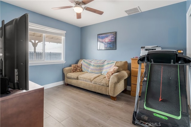 living room with hardwood / wood-style flooring and ceiling fan