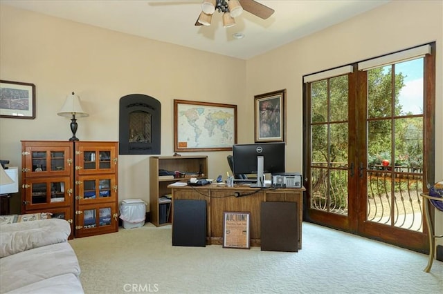 carpeted office space with french doors and ceiling fan