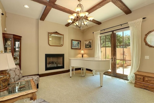 sitting room with baseboards, beamed ceiling, and carpet floors