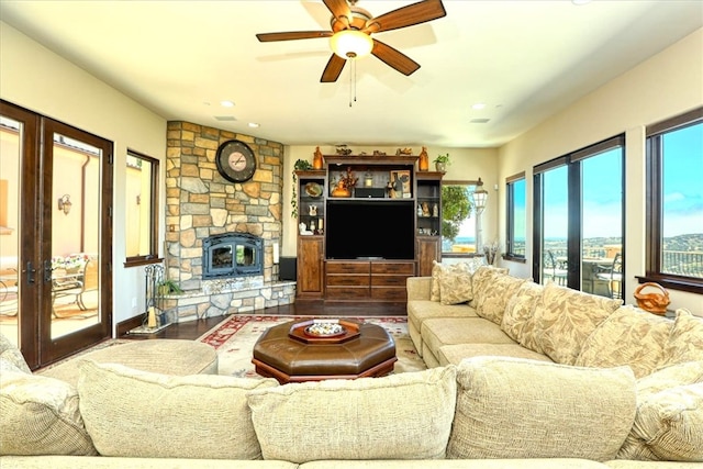 living area with ceiling fan and wood finished floors