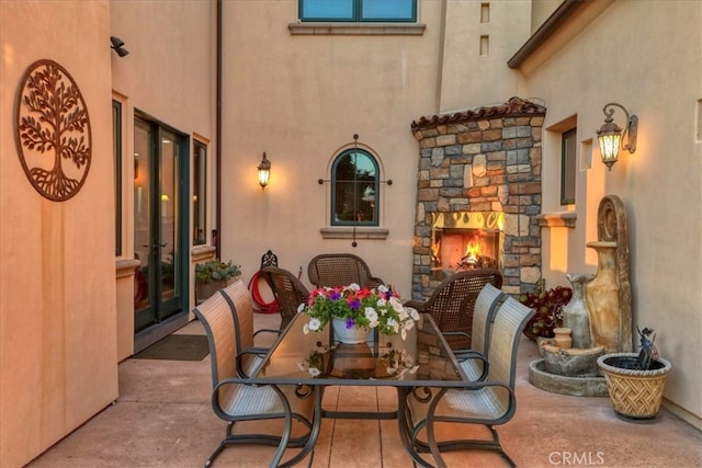 view of patio / terrace featuring an outdoor stone fireplace