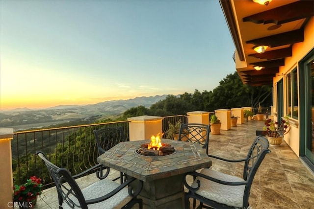 balcony with a mountain view and an outdoor fire pit