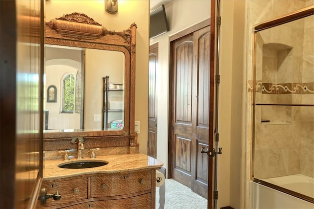 full bath with combined bath / shower with glass door and vanity