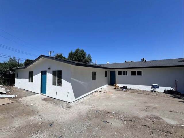 back of house with a patio