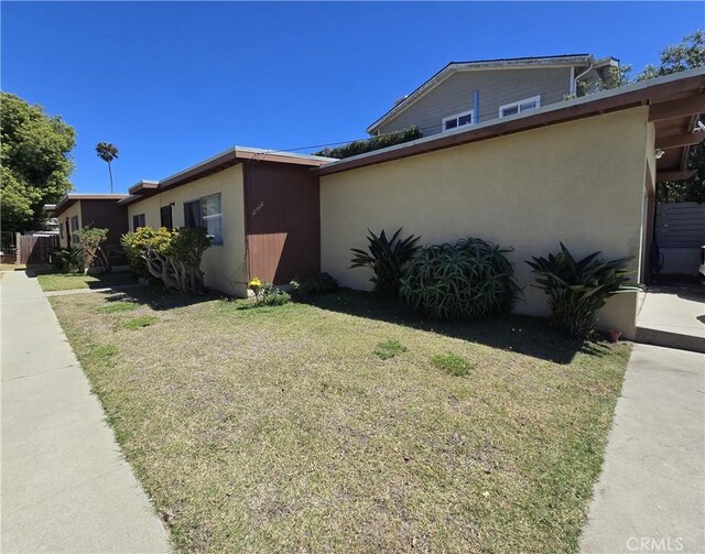 view of side of home featuring a lawn