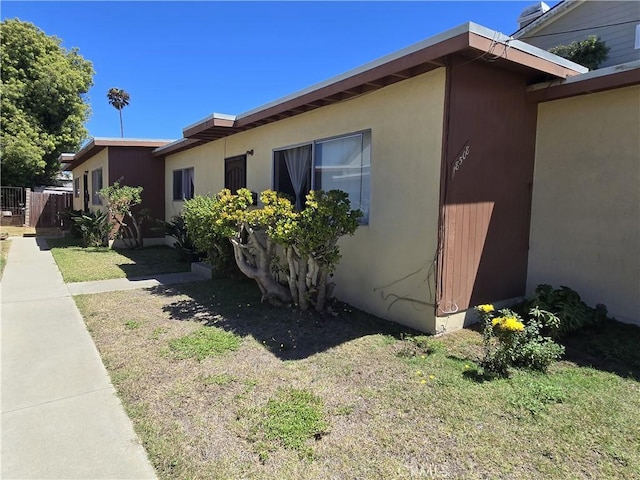 view of side of home with a yard