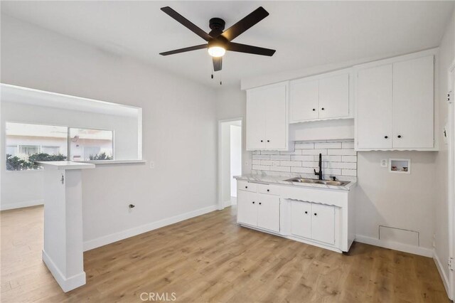 18508 Mansel Ave, Redondo Beach, CA 90278 - kitchen with a sink, backsplash, light countertops, ceiling fan, and white cabinetry