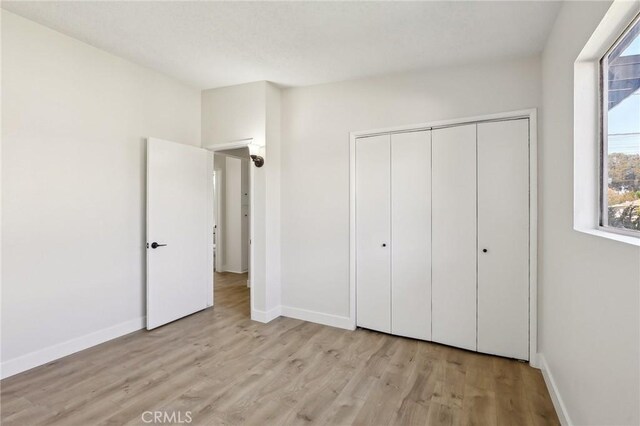 18508 Mansel Ave, Redondo Beach, CA 90278 - unfurnished bedroom with wood finished floors, baseboards, and a closet