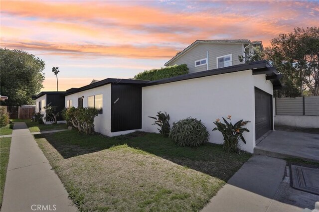 18508 Mansel Ave, Redondo Beach, CA 90278 - property exterior at dusk with concrete driveway, a garage, and stucco siding