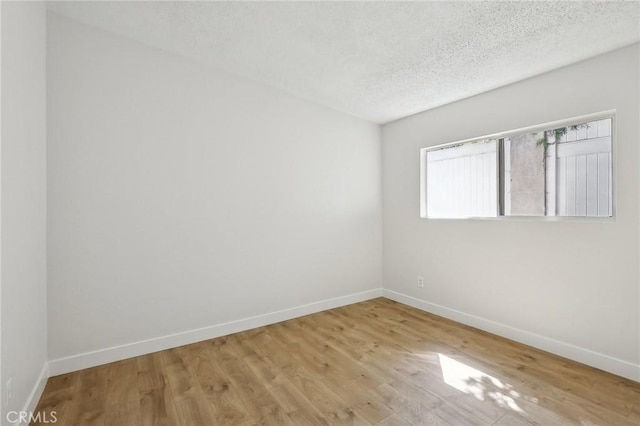 18508 Mansel Ave, Redondo Beach, CA 90278 - empty room featuring baseboards, wood finished floors, and a textured ceiling