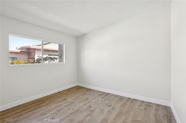 18508 Mansel Ave, Redondo Beach, CA 90278 - spare room featuring wood finished floors, baseboards, and a textured ceiling
