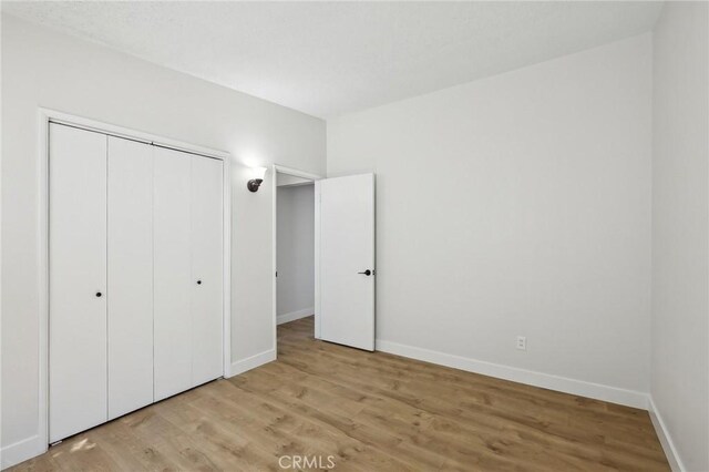 18508 Mansel Ave, Redondo Beach, CA 90278 - unfurnished bedroom with light wood-type flooring, baseboards, and a closet