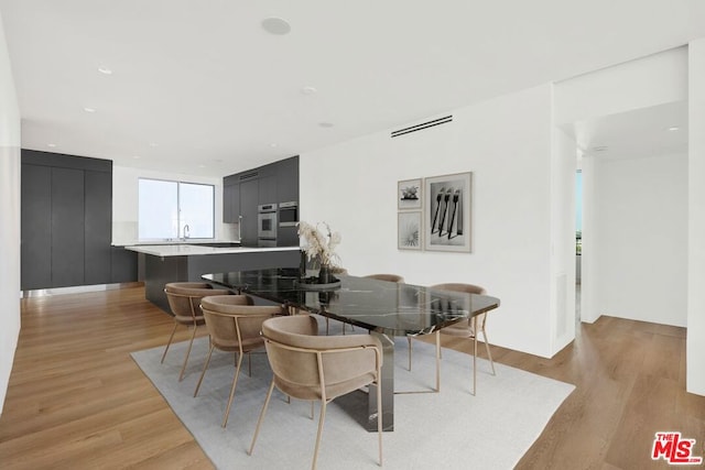 dining area with light hardwood / wood-style floors