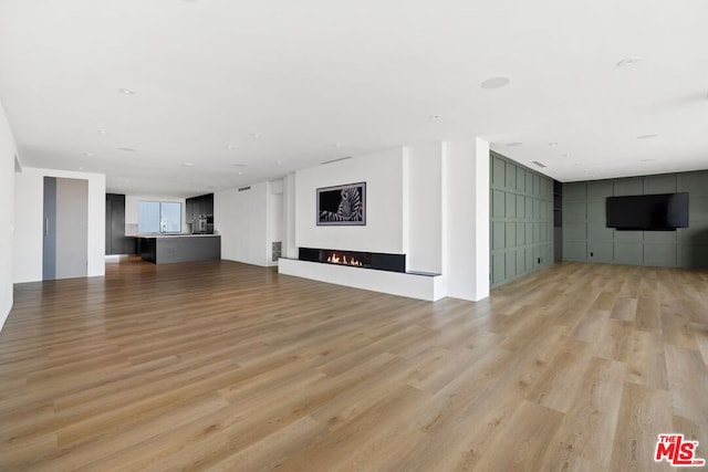 unfurnished living room with light wood-type flooring