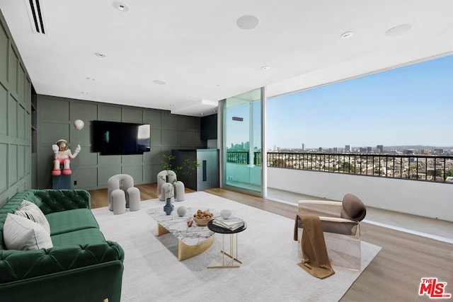 living room featuring light hardwood / wood-style floors and floor to ceiling windows