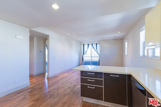 kitchen featuring hardwood / wood-style floors, dark brown cabinets, kitchen peninsula, ornamental molding, and stainless steel dishwasher