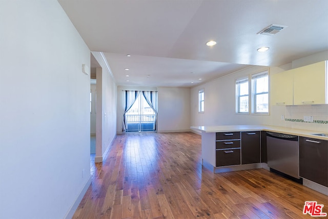 kitchen featuring dishwasher, dark hardwood / wood-style floors, kitchen peninsula, and a wealth of natural light