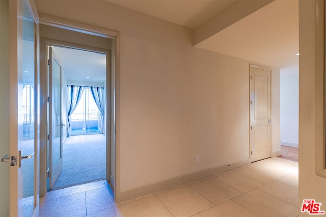 hallway with light tile patterned flooring