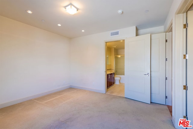 unfurnished bedroom featuring light carpet