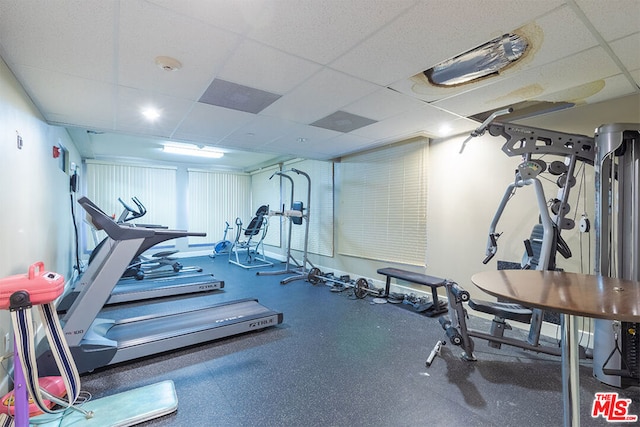 workout area with a paneled ceiling