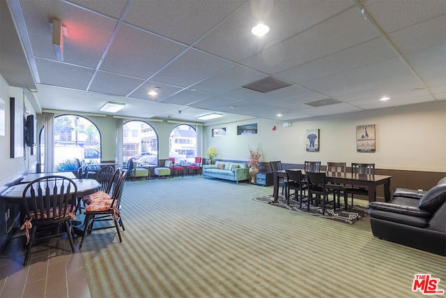 carpeted dining room featuring plenty of natural light and a drop ceiling