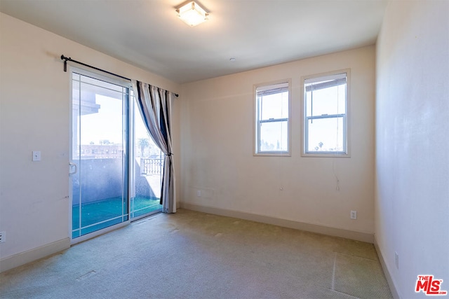 spare room with light colored carpet