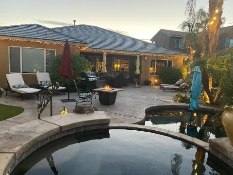 exterior space with a patio area and an outdoor fire pit