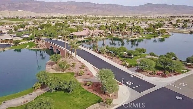 birds eye view of property with a water and mountain view