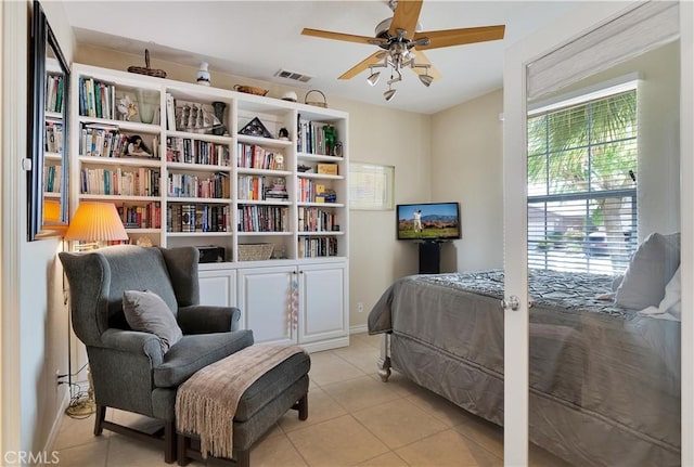 bedroom with ceiling fan and light tile patterned flooring