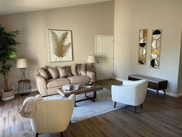 living room featuring lofted ceiling, a textured ceiling, and dark hardwood / wood-style flooring